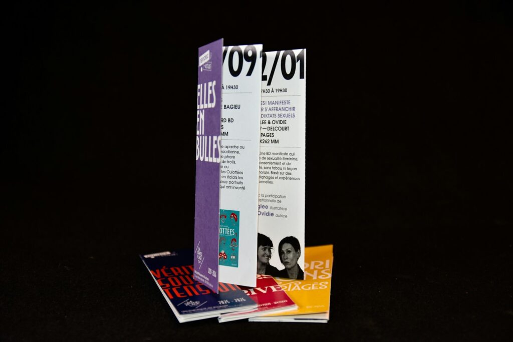 Folded brochures and pamphlets stacked together, showing the kind of printed leaflets businesses hand out