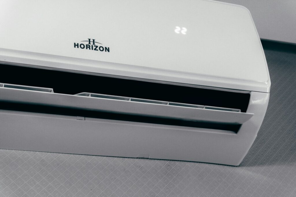 White air conditioner unit displaying 22 degrees, set to keep a home comfortably cool