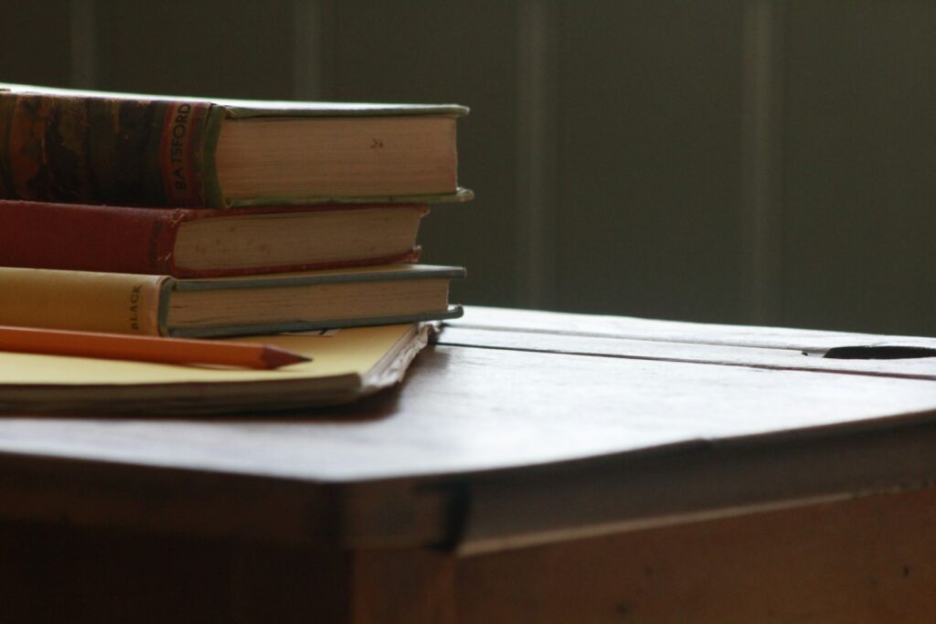 Vintage books on an old school desk, suggesting study and careers beyond the traditional legal route